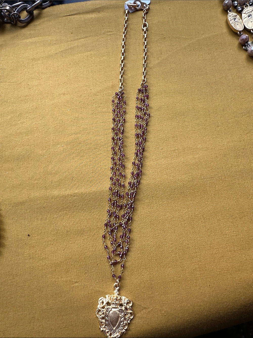 Gold Shield Pendant Multi-Strand Necklace with Purple Beads